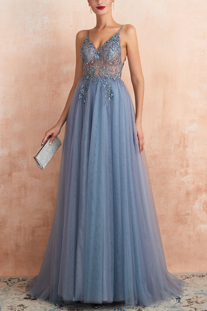 Frau in blauem Abendkleid mit Spitze, hält silberne Clutch, elegantes Ballkleid, Abendmode.